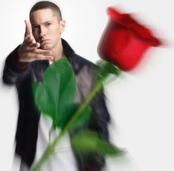 The rapper Eminem throwing a rose at the camera